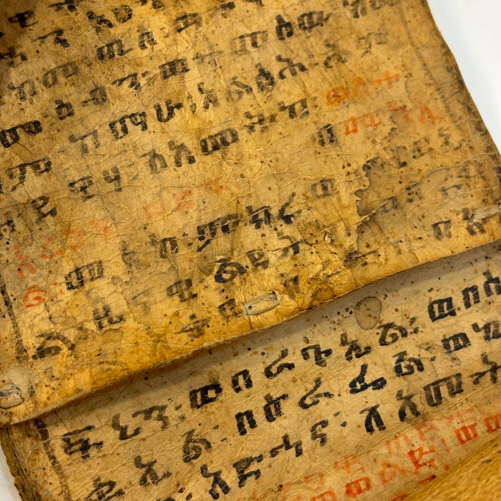 Ethiopian Manuscript Healing Scroll 4" x 82" with 3 images and 191 lines of text in three sheets of hide, connected with leather stitches — photograph 4.