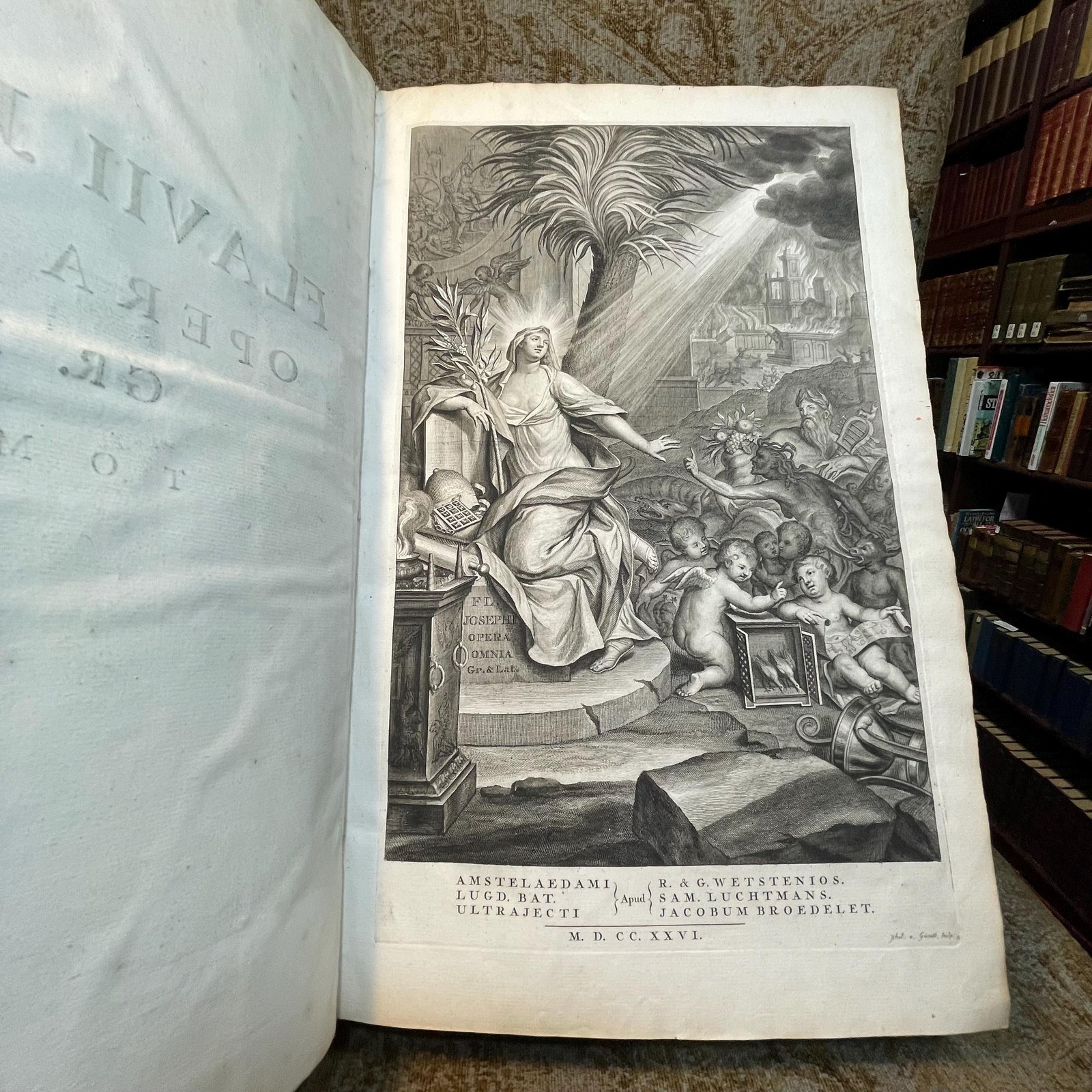 Flavii Josephi Quae Reperiri Potuerunt, Opera Omnia Graece et Latine, Cum Notis & Nova Versione Joannis Hudsoni, S.T.P. Aulae B. Mariae Virginis Principalis, & Bibliothecarii Bodlejani. Accedunt Nunc Primum Notae Integrae, ad Graeca Josephi & Varios Ejusdem Libros, D. Eduardi Bernardi, Jacobi Gronovii, Francisci Combefisii, Jo. Sibrandae, Hendr. Aldrichii. Ut & Ineditae In Universa Fl. Josephi Opera, Joannis Covvei, Ezechielis Spanhemii, Hadriani Relandi, & Selectae Aliorum. Adjiciuntur In Fine Caroli Daubuz Libri duo pro Testimonio Fl. Josephi de Jesu Christo; Et ejusdem Argumenti Epistolae XXX. virorum Doctorum, ut Reinesii, Snellii, Jo. Fr. Gronovii aliorumque, Philologicae & Historicae; ut & Petri Brinch Examen Chronologiae & Historiae Josephicae; Jo. Baptist. Ottii Animadversiones as Josephum & specimen Levici Flaviani; Christ. Noldii Historia Ideumaea, seu de Vita & Gestis Herodum &c. &c. Quorum Syllabus exstat ante Libri Primi Antiquitatum. Omnia collegit, disposuit, & post Jo. Hudsonum ad Codices fere omnes, cum inpressos, tum Manuscriptos, praecipue Lugduno-Batavos, diligenter recensuit, Notasque passim suas, & quinque in fibe Indices adjecit Sigebertus Havercampus; Linguae Graeca, Historiarum & Eloquentiae Professor, in Academia, quae Lugduni est, Batava. Tomis Duobus. Translated from Latin: "The Complete Works of Flavius Josephus That Could Be Found, in Greek and Latin, with Notes & a New Translation by John Hudson, S.T.P., Principal of St. Mary’s Hall and Bodleian Librarian. Additional Notes for the Greek Texts of Josephus and Various Books, by Edward Bernard, Jacob Gronovius, Francis Combefis, John Sibranda, Henry Aldrich. Also Added for the First Time are the Unpublished Notes on All of Flavius Josephus's Works by John Covell, Ezechiel Spanheim, Adriaan Reland, and Selected Others. Included at the End are Two Books by Charles Daubuz in Defense of Flavius Josephus's Testimony About Jesus Christ, as well as 30 Epistles of Learned Men on the Same Subject, such as Reinesius, Snellius, John Frederic Gronovius, and Others, Philological & Historical. Furthermore, Peter Brinch’s Examination of the Chronology and History of Josephus; John Baptist Ott’s Observations on Josephus and Specimen of Flavian Levite; Christian Nold's History of Idumea, or the Life & Acts of the Herods, etc., etc., the List of Which is Found Before the First Book of Antiquities. All Collected, Organized, and After John Hudson Were Carefully Reviewed Against Almost All the Codices, Both Printed and Manuscript, Especially Those of Leiden, with Notes Throughout by Sigebert Havercamp, Professor of the Greek Language, History, and Eloquence at the Academy of Leiden. In Two Volumes." — photograph 2.