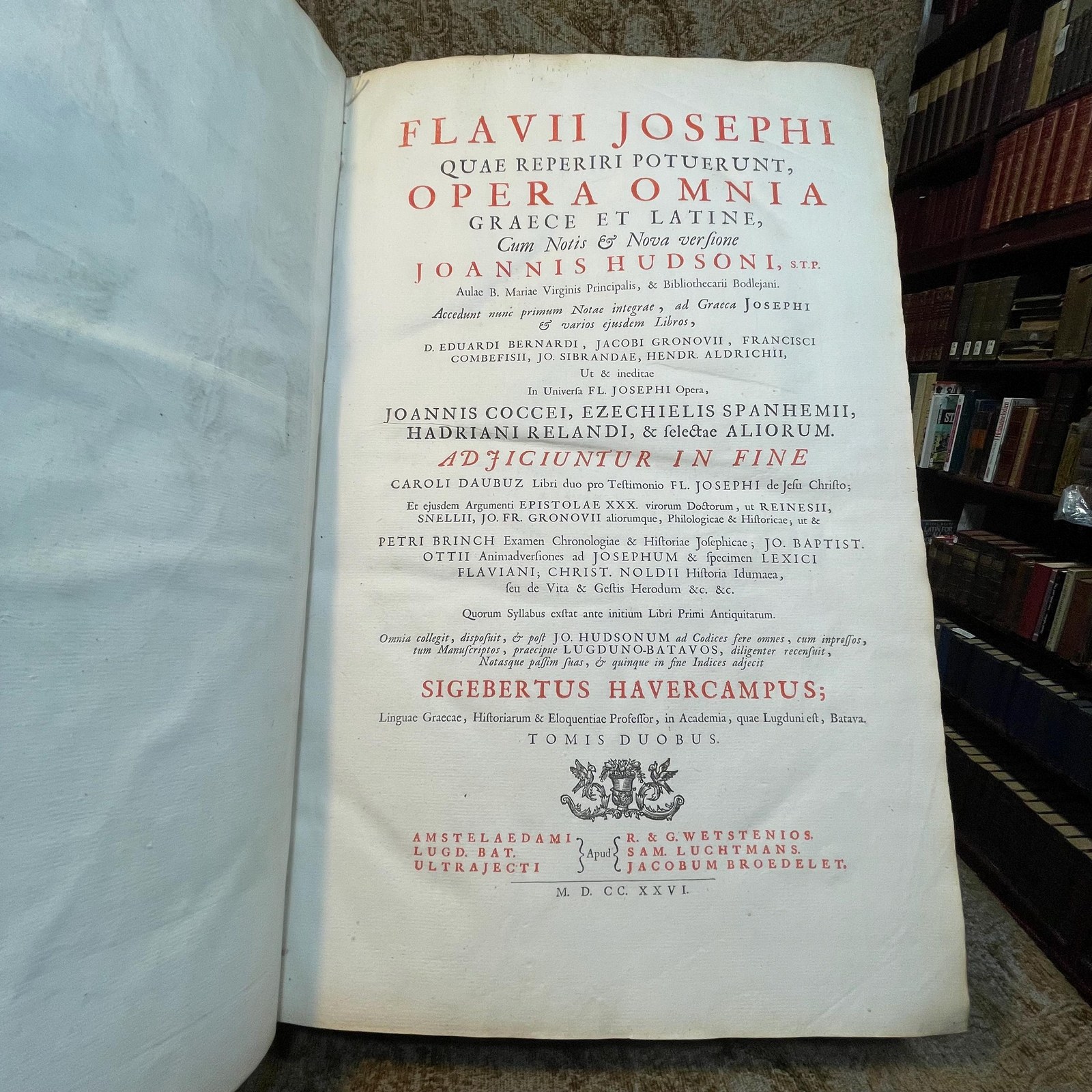 Flavii Josephi Quae Reperiri Potuerunt, Opera Omnia Graece et Latine, Cum Notis & Nova Versione Joannis Hudsoni, S.T.P. Aulae B. Mariae Virginis Principalis, & Bibliothecarii Bodlejani. Accedunt Nunc Primum Notae Integrae, ad Graeca Josephi & Varios Ejusdem Libros, D. Eduardi Bernardi, Jacobi Gronovii, Francisci Combefisii, Jo. Sibrandae, Hendr. Aldrichii. Ut & Ineditae In Universa Fl. Josephi Opera, Joannis Covvei, Ezechielis Spanhemii, Hadriani Relandi, & Selectae Aliorum. Adjiciuntur In Fine Caroli Daubuz Libri duo pro Testimonio Fl. Josephi de Jesu Christo; Et ejusdem Argumenti Epistolae XXX. virorum Doctorum, ut Reinesii, Snellii, Jo. Fr. Gronovii aliorumque, Philologicae & Historicae; ut & Petri Brinch Examen Chronologiae & Historiae Josephicae; Jo. Baptist. Ottii Animadversiones as Josephum & specimen Levici Flaviani; Christ. Noldii Historia Ideumaea, seu de Vita & Gestis Herodum &c. &c. Quorum Syllabus exstat ante Libri Primi Antiquitatum. Omnia collegit, disposuit, & post Jo. Hudsonum ad Codices fere omnes, cum inpressos, tum Manuscriptos, praecipue Lugduno-Batavos, diligenter recensuit, Notasque passim suas, & quinque in fibe Indices adjecit Sigebertus Havercampus; Linguae Graeca, Historiarum & Eloquentiae Professor, in Academia, quae Lugduni est, Batava. Tomis Duobus. Translated from Latin: "The Complete Works of Flavius Josephus That Could Be Found, in Greek and Latin, with Notes & a New Translation by John Hudson, S.T.P., Principal of St. Mary’s Hall and Bodleian Librarian. Additional Notes for the Greek Texts of Josephus and Various Books, by Edward Bernard, Jacob Gronovius, Francis Combefis, John Sibranda, Henry Aldrich. Also Added for the First Time are the Unpublished Notes on All of Flavius Josephus's Works by John Covell, Ezechiel Spanheim, Adriaan Reland, and Selected Others. Included at the End are Two Books by Charles Daubuz in Defense of Flavius Josephus's Testimony About Jesus Christ, as well as 30 Epistles of Learned Men on the Same Subject, such as Reinesius, Snellius, John Frederic Gronovius, and Others, Philological & Historical. Furthermore, Peter Brinch’s Examination of the Chronology and History of Josephus; John Baptist Ott’s Observations on Josephus and Specimen of Flavian Levite; Christian Nold's History of Idumea, or the Life & Acts of the Herods, etc., etc., the List of Which is Found Before the First Book of Antiquities. All Collected, Organized, and After John Hudson Were Carefully Reviewed Against Almost All the Codices, Both Printed and Manuscript, Especially Those of Leiden, with Notes Throughout by Sigebert Havercamp, Professor of the Greek Language, History, and Eloquence at the Academy of Leiden. In Two Volumes." — photograph 4.