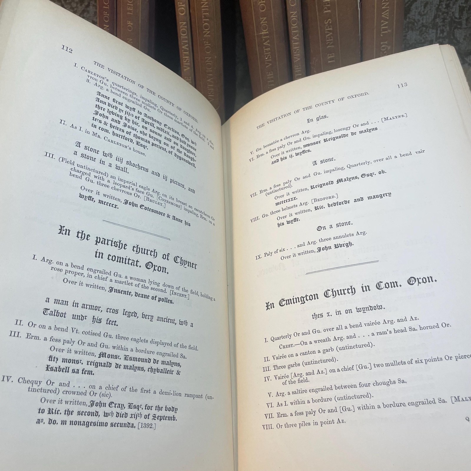 The Publications of The Harleian Society. Established A.D. 1869. Nine volumes comprising Vol.I.:The Visitation of London in the Year 1568. Taken by Robert Cooke…And Since Augmented Both With Descents and Arms. (London, 1869); Vol.II.: The Visitation of The Conty of Leicester In The Year 1619. Taken by William Camden.., Edited by John Fetherston. (London, 1870); Vol.III.:The Visitation of the County of Rutland In the Year 1618-19. Taken by William Camden... And Other Descents of Families Not in the Visitation. (London, 1870); Vol. IV.: The Visitations of The County of Nottingham In The Years 1569 and 1614, With Many other Descents of the Same County. Edited by George William Marshall, LL.M. (London, 1871); Vol. V.: The Visitations of The County of Oxford Taken in The Years 1566 by William Harvey, Clarencieux; 1574 by Richard Lee, Portcullis,.. and in 1634 by John Philpot, Somerset, and William Ryley, Bluemantle... Together with The Gatherings of Oxfordshire, Collected by Richard Lee in 1574. Edited and Annotated by William Henry Turner. (London, 1871); Vol. VI.: The Visitation of The County of Devon In The Year 1620. Edited by Frederic Thomas Colby (London, 1872); Vol.VII.: The Visitation of The County of Cumberland In The Year 1615. Taken by Richard St, George... Edited by John Fetherstone, F.S.A.(London, 1872); Vol. VIII.: Le Neve's Pedigrees of The Knights made By King Charles II., King James II., King William III. and Queen Mary, King William Alone, and Queen Anne. Edited by George w. Marshall, LL.D...(LOndon, 1873); Vol. IX.: The Visitation of the County of Cornwall, In The Year 1620. Edited by Lieut.-Colonel J.L. Vivian and Henry H. Drake, M.A., Ph.D....(London, 1874). Nine volumes total. — photograph 8.