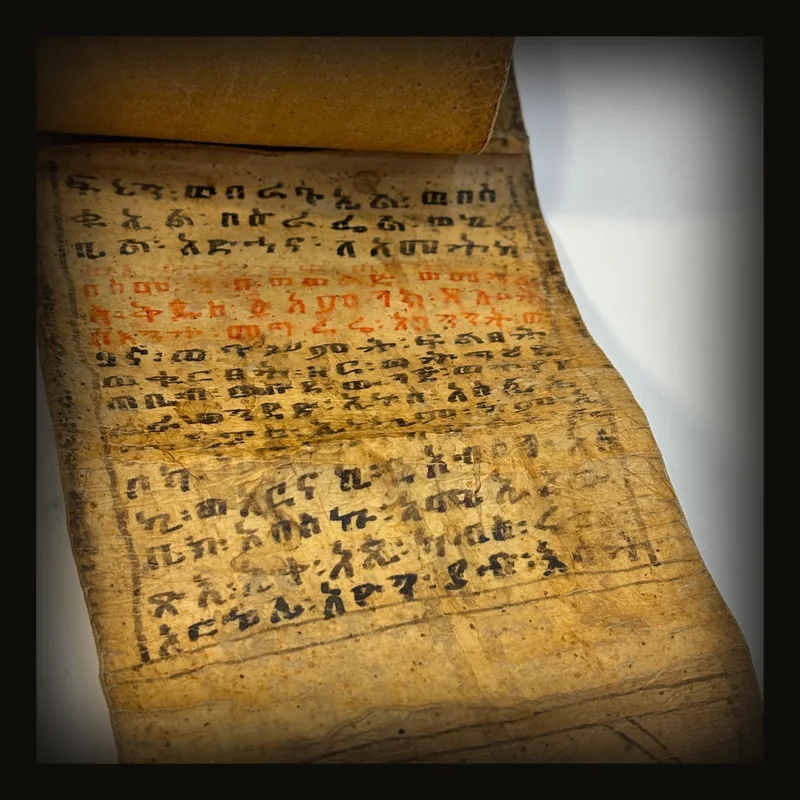 Ethiopian Manuscript Healing Scroll 4" x 82" with 3 images and 191 lines of text in three sheets of hide, connected with leather stitches.
